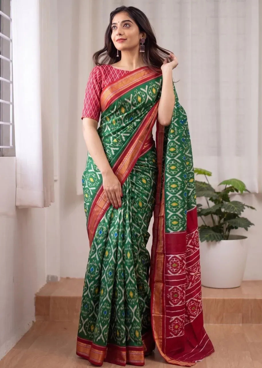 Green mulmul cotton saree with red patterned blouse and zari border on model