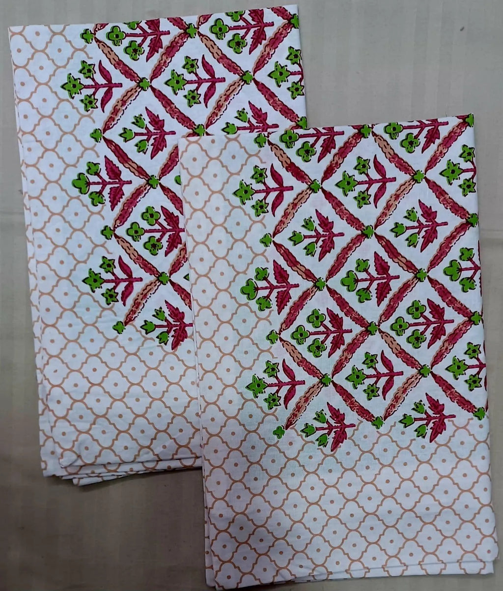 White and pink floral printed cotton pillow covers folded neatly