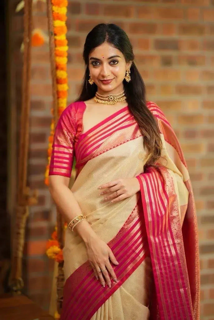 Front facing single model wearing cream and pink soft silk saree