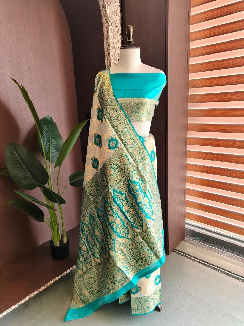 White and turquoise soft tissue silk saree with rich zari woven pallu on mannequin