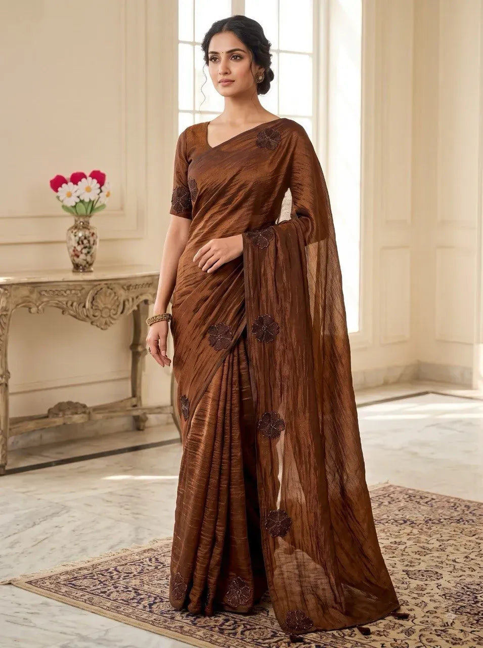 Model wearing brown space silk saree with floral embroidery