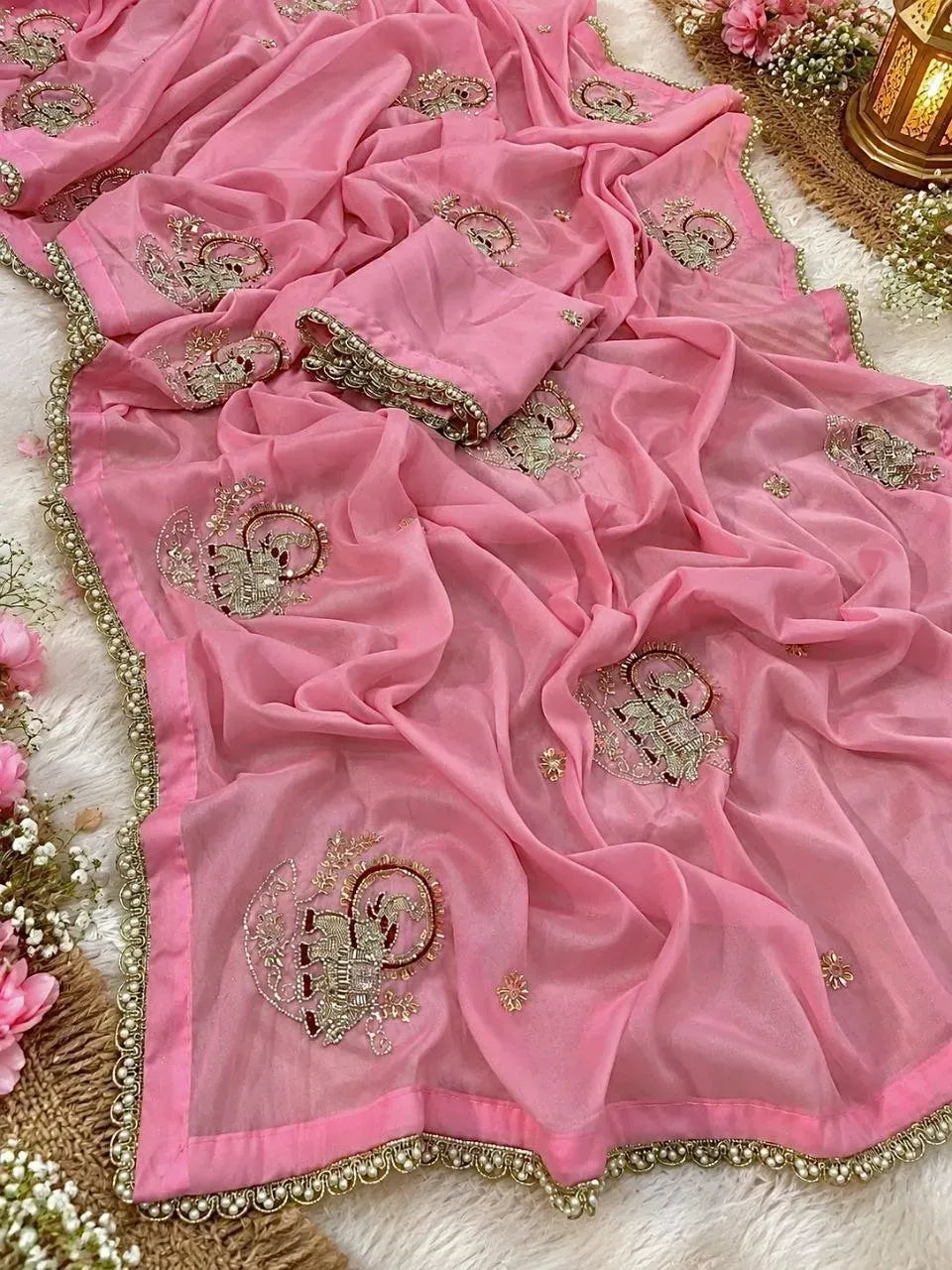 Pink georgette saree with heavy elephant motif embroidery and pearl border