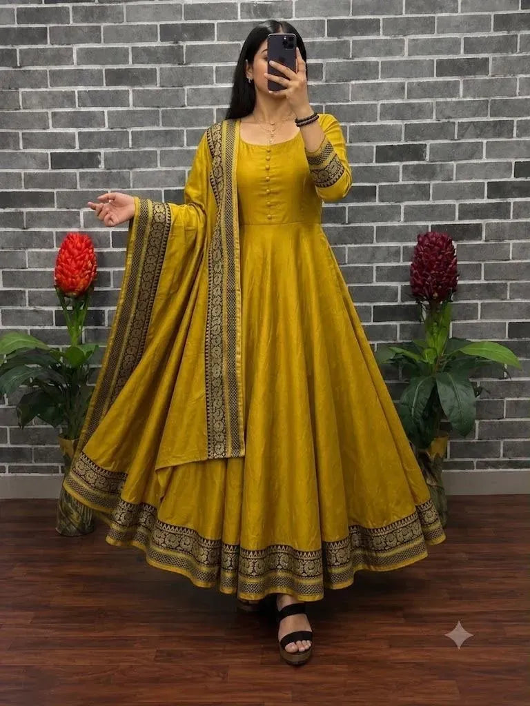 Woman wearing yellow vichitra silk kurti with dupatta and border work