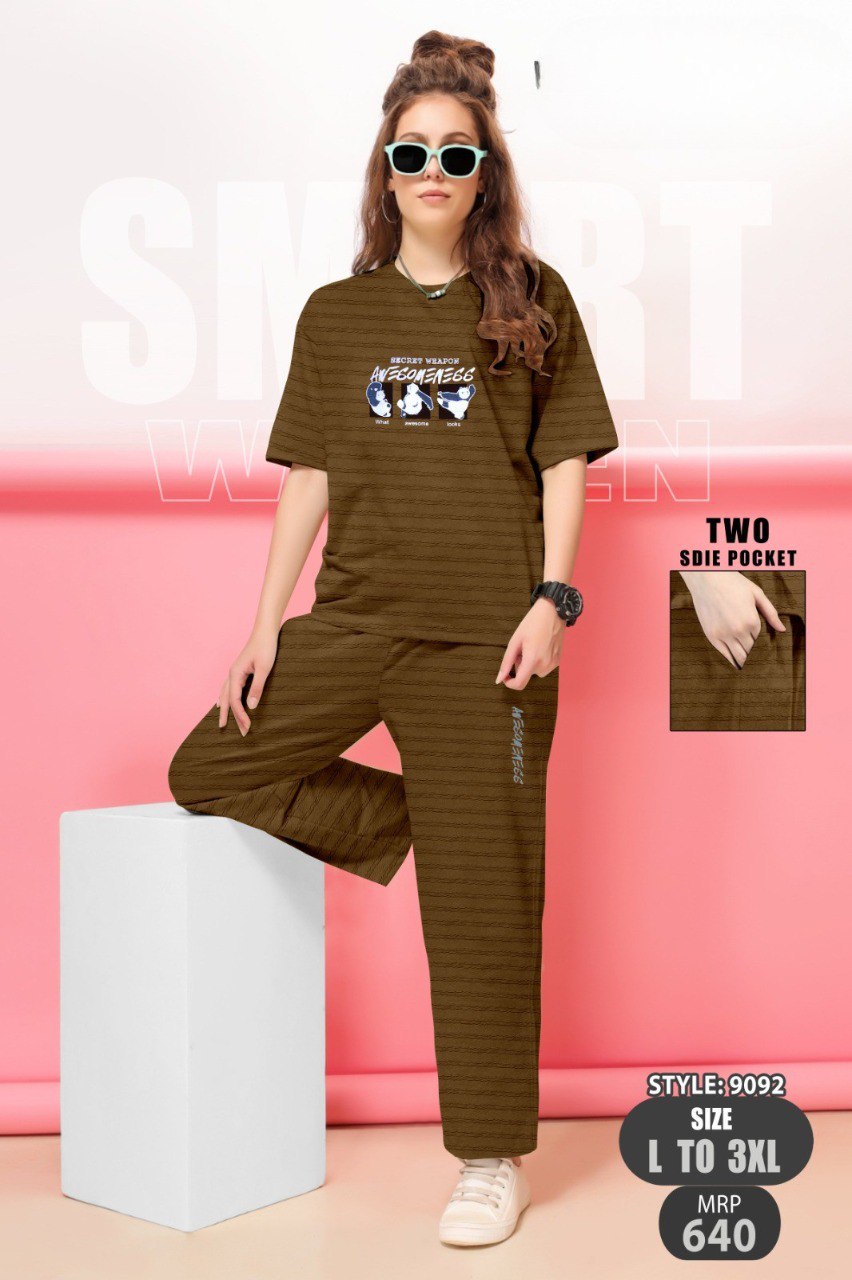 Woman wearing brown striped bubble co-ord set with graphic print and sunglasses.