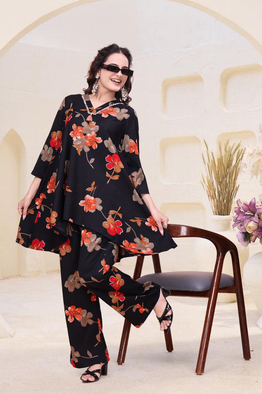 Woman posing in black floral printed designer co-ord set with V-neck top and palazzo pants