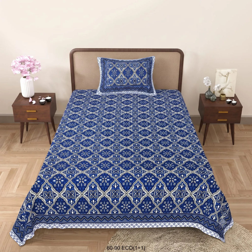 Blue geometric print single bedsheet with matching pillow cover on wooden bed