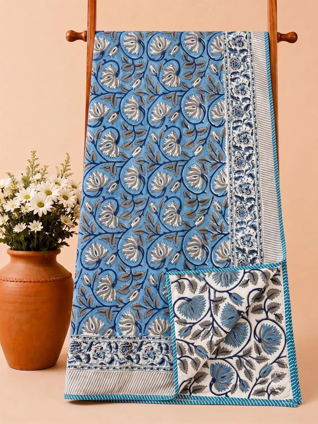 Blue floral hand block printed pure cotton reversible dohar hanging on wooden rack