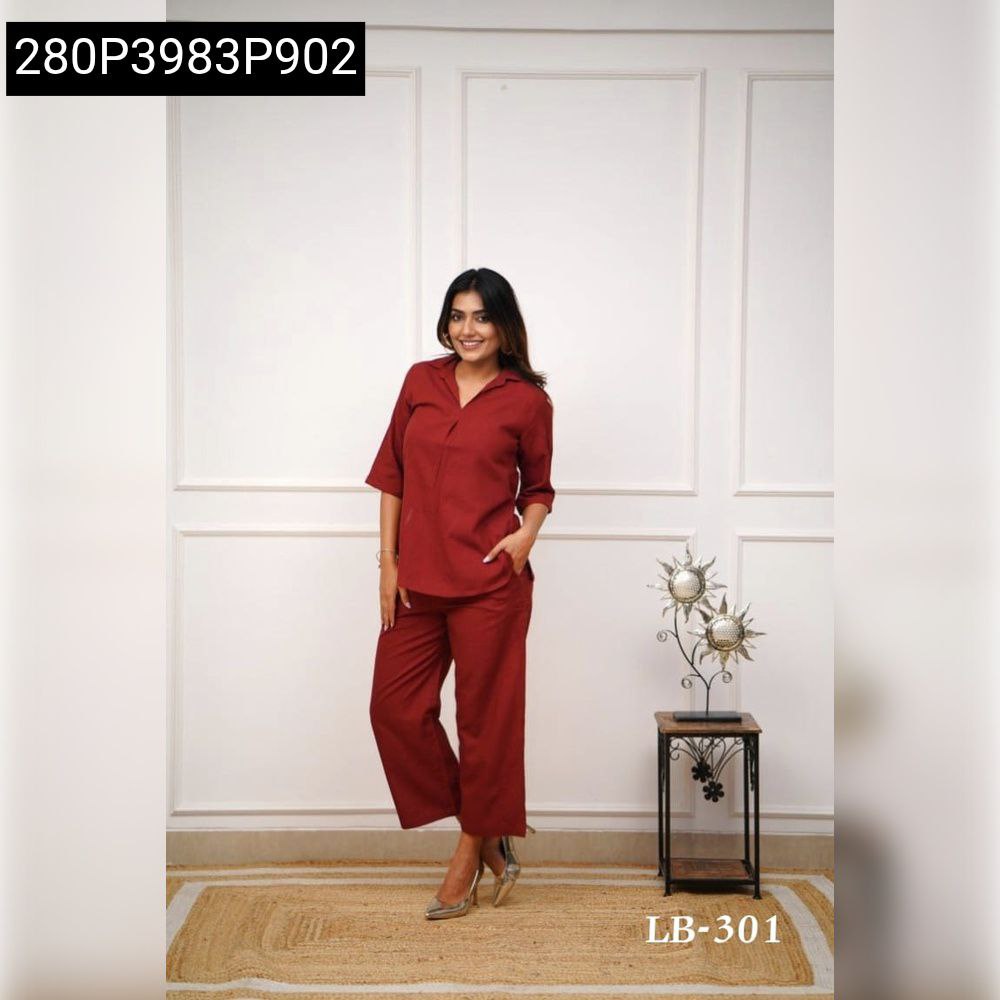 Full shot of model in maroon rayon top and wide-leg pants, posing elegantly.