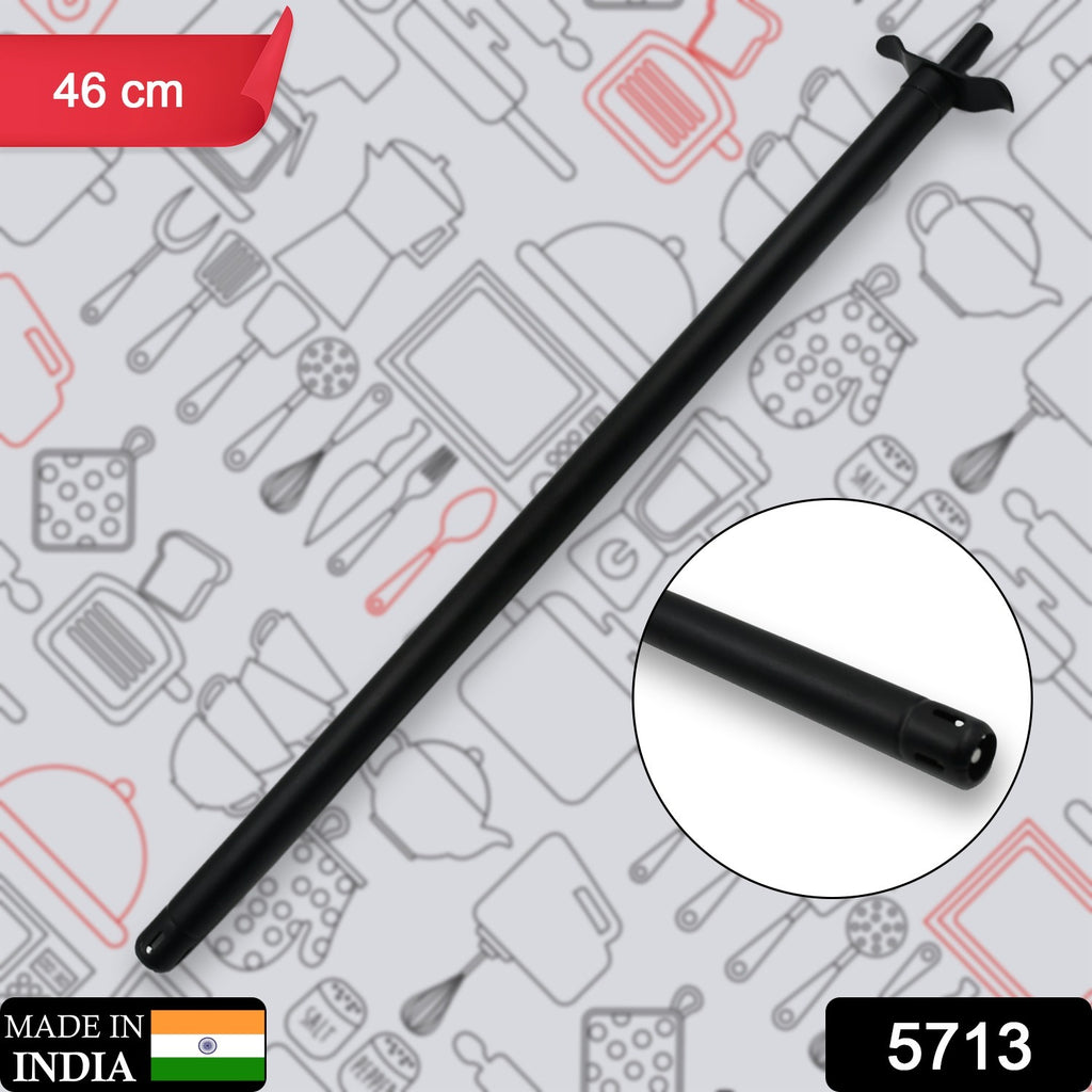Unbreakable long stainless steel gas lighter igniting a kitchen gas stove.