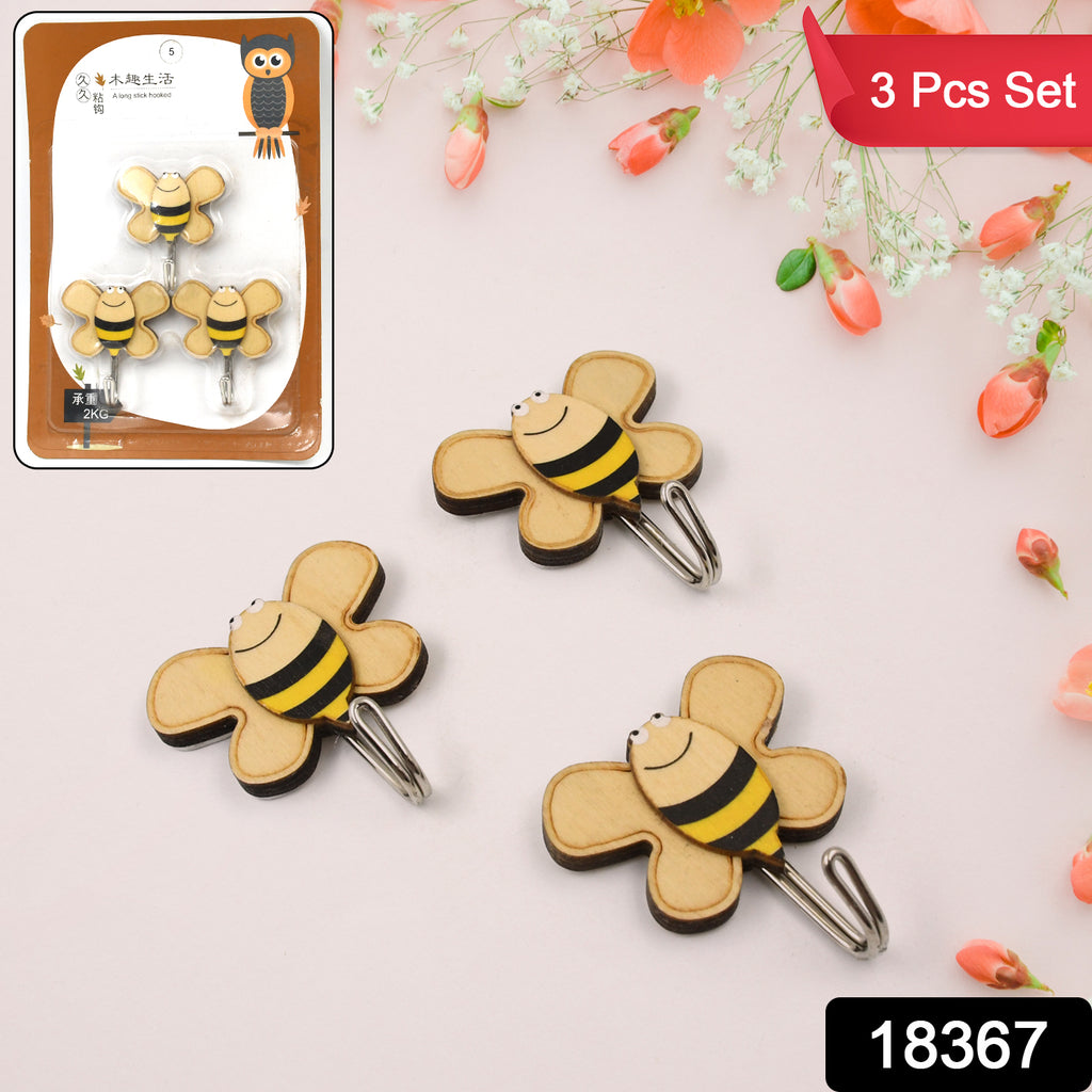 Multipurpose self-adhesive hooks (3 pc set), transparent, on a white wall holding utensil