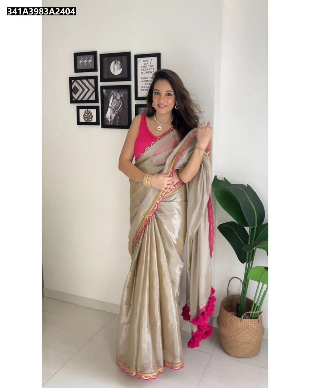 Elegant woman posing in a radiant Champagne Gold Uppada Tissue Silk Saree with pink blouse and intricate lace border, perfect for celebrations