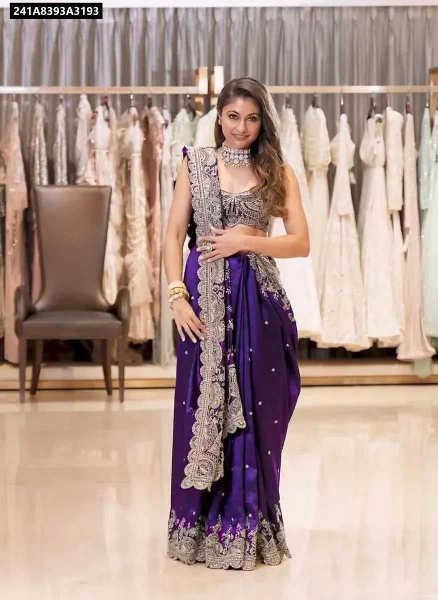 Model posing in a stunning purple Rangoli silk embroidered saree with rich gold sequence work and matching blouse, elegant for festive occasions.