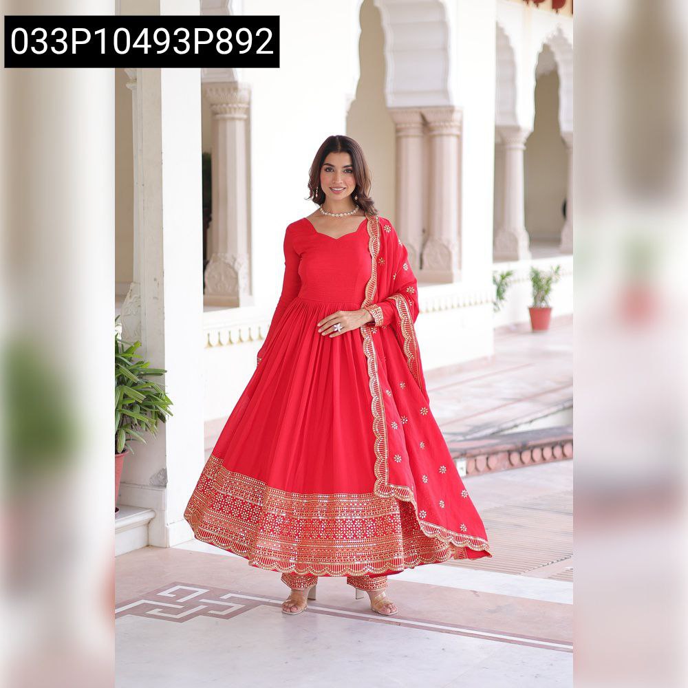 Model in a beautiful red Vichitra silk embroidered gown, posing gracefully.