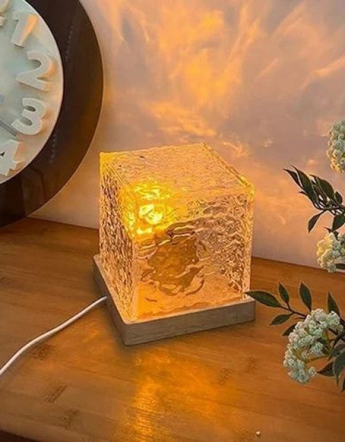 Rotating water ripple night light projecting a warm, dynamic aura pattern.