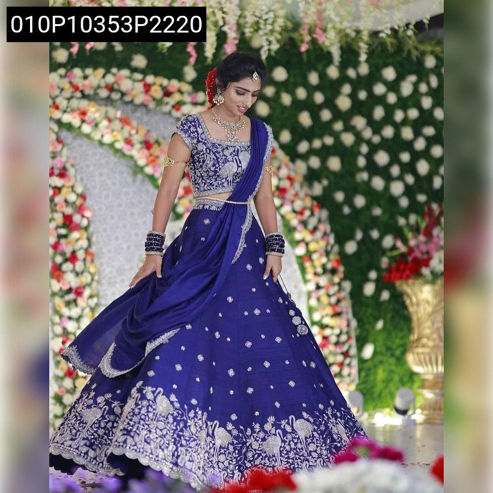 Model posing in Royal Blue Sequence Embroidered Lehenga with full flair against a floral backdrop.