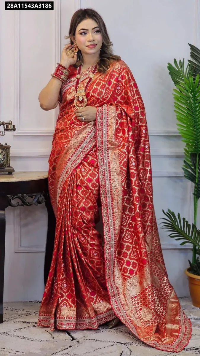 A woman elegantly posing in a red Russian Bandhej silk pattu saree with antique weaving and a rich pallu, perfect for festive occasions.