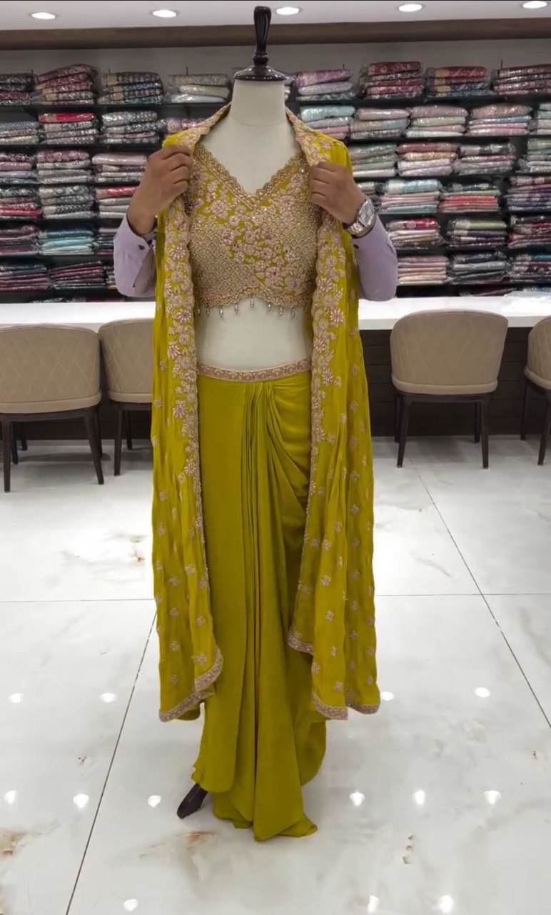 Mannequin in sequined olive green three-piece ethnic set with shrug, front view