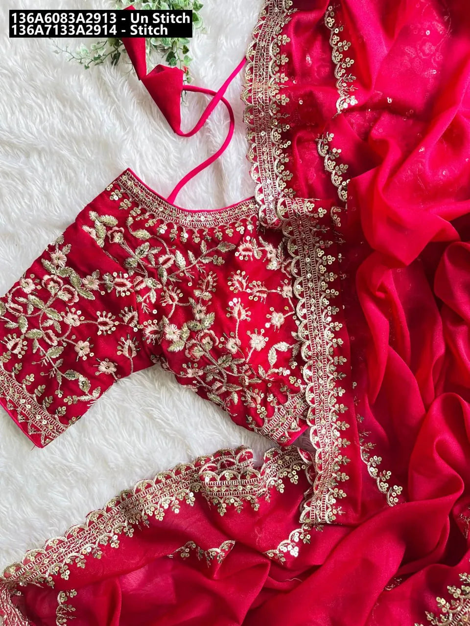 Elegant red shimmer georgette saree with intricate gold zari and sequin embroidered blouse on a white fluffy background.