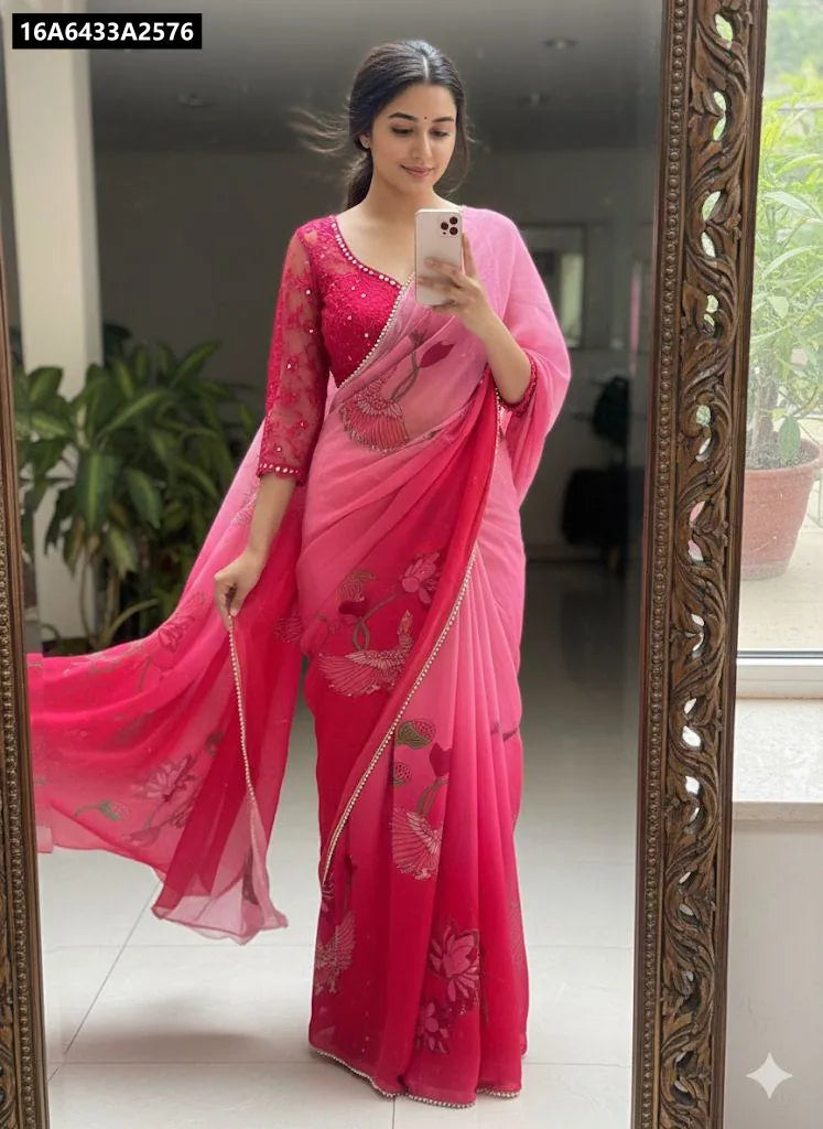 A stylish model poses in a full-length mirror, showcasing the stunning pink and fuchsia ombre georgette silk saree with digital prints and val moti handwork. She wears a matching embroidered blouse.
