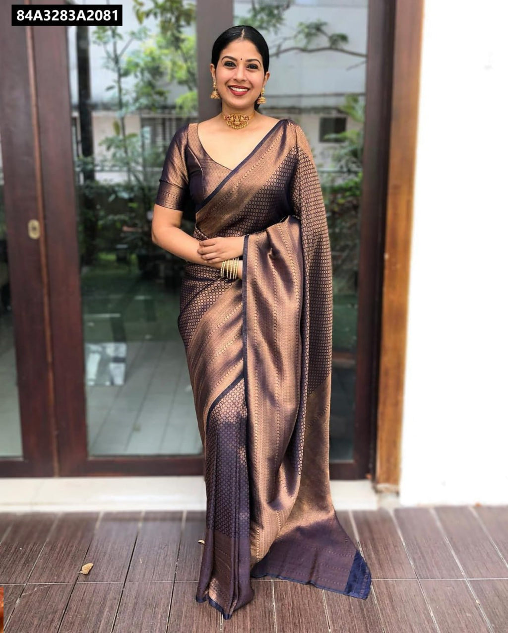 Elegant woman smiling in a full shot, wearing an Espresso Bronze Soft Lichi Silk Saree with intricate jacquard weave, perfect for festive occasions.