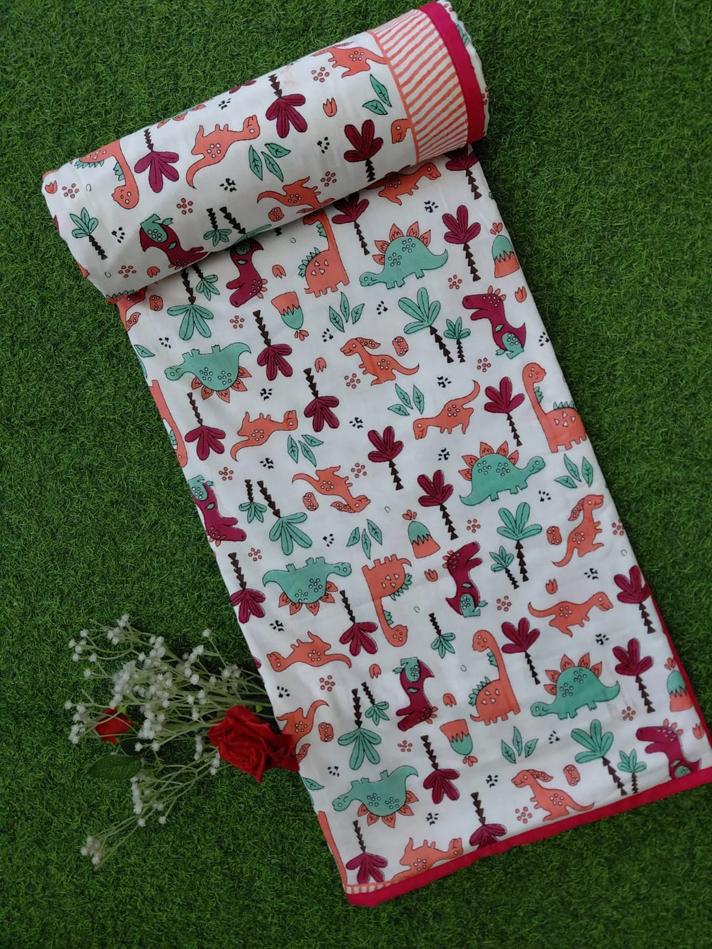 White mulmul cotton kids dohar with colorful dinosaur print and pink border