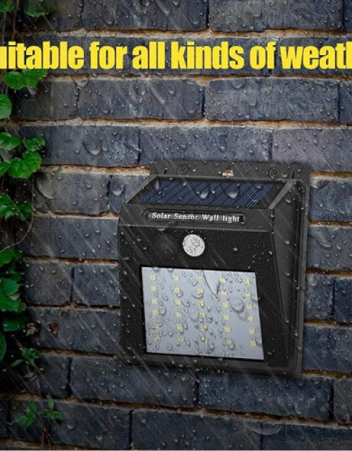 Black solar sensor wall light with multiple LEDs