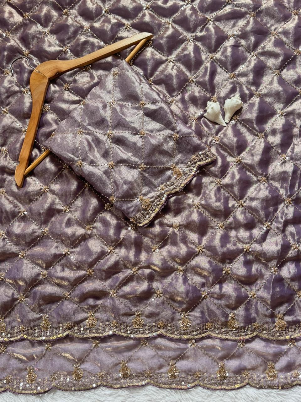 Lavender Space Silk Saree with intricate beadwork and matching blouse on wooden hanger