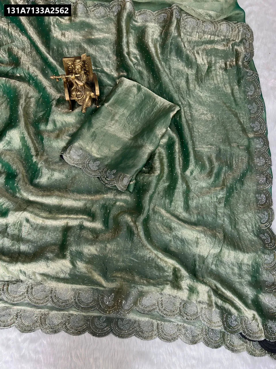 TRENDBUY Space Silk Jarkhan Work Saree in Emerald Green, flat lay with blouse piece and decorative idol