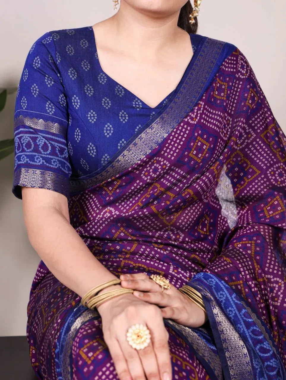 Model wearing purple and blue bandhej print chanderi saree with zari border