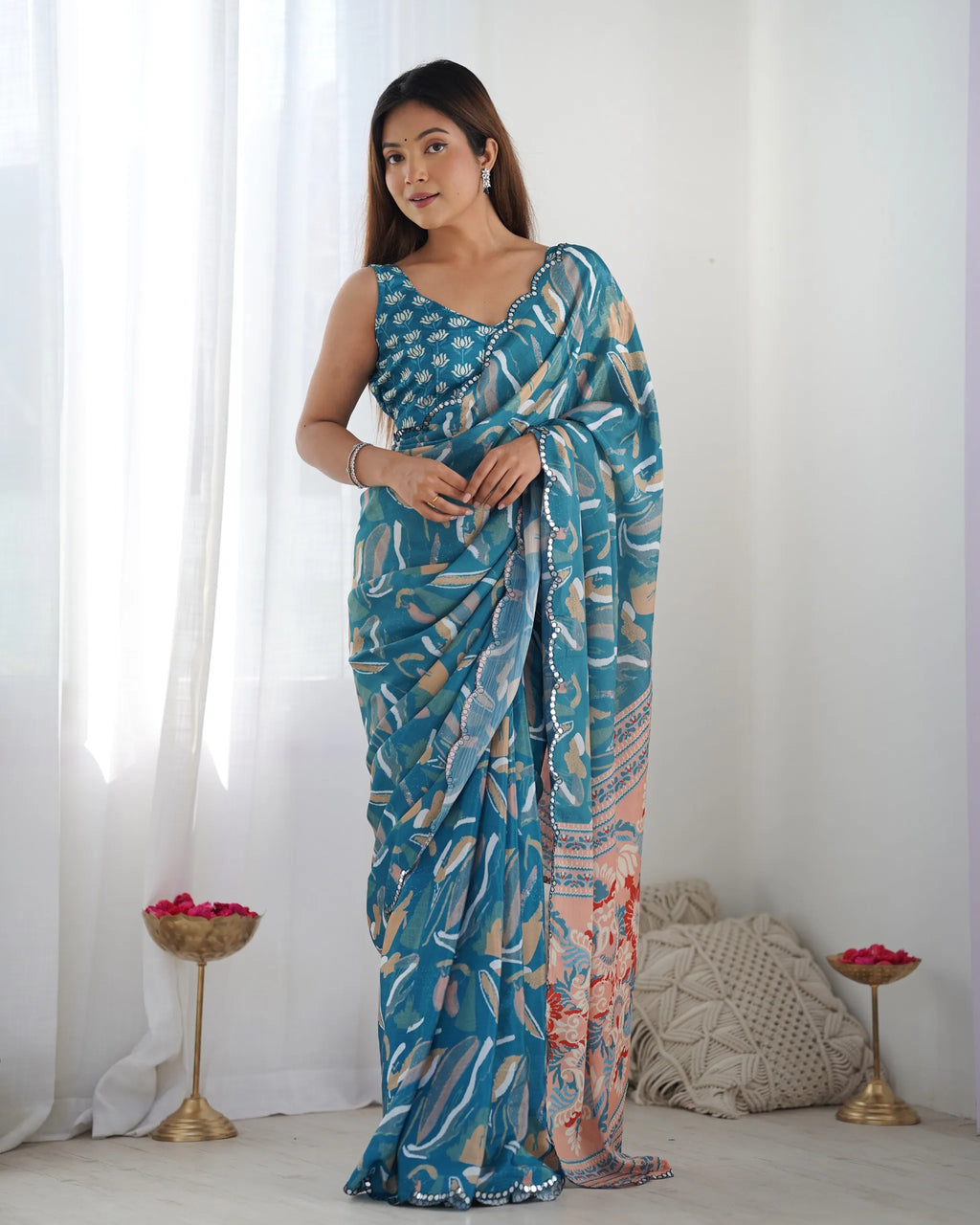 Model posing gracefully in printed party wear chinnon saree with mirror lace