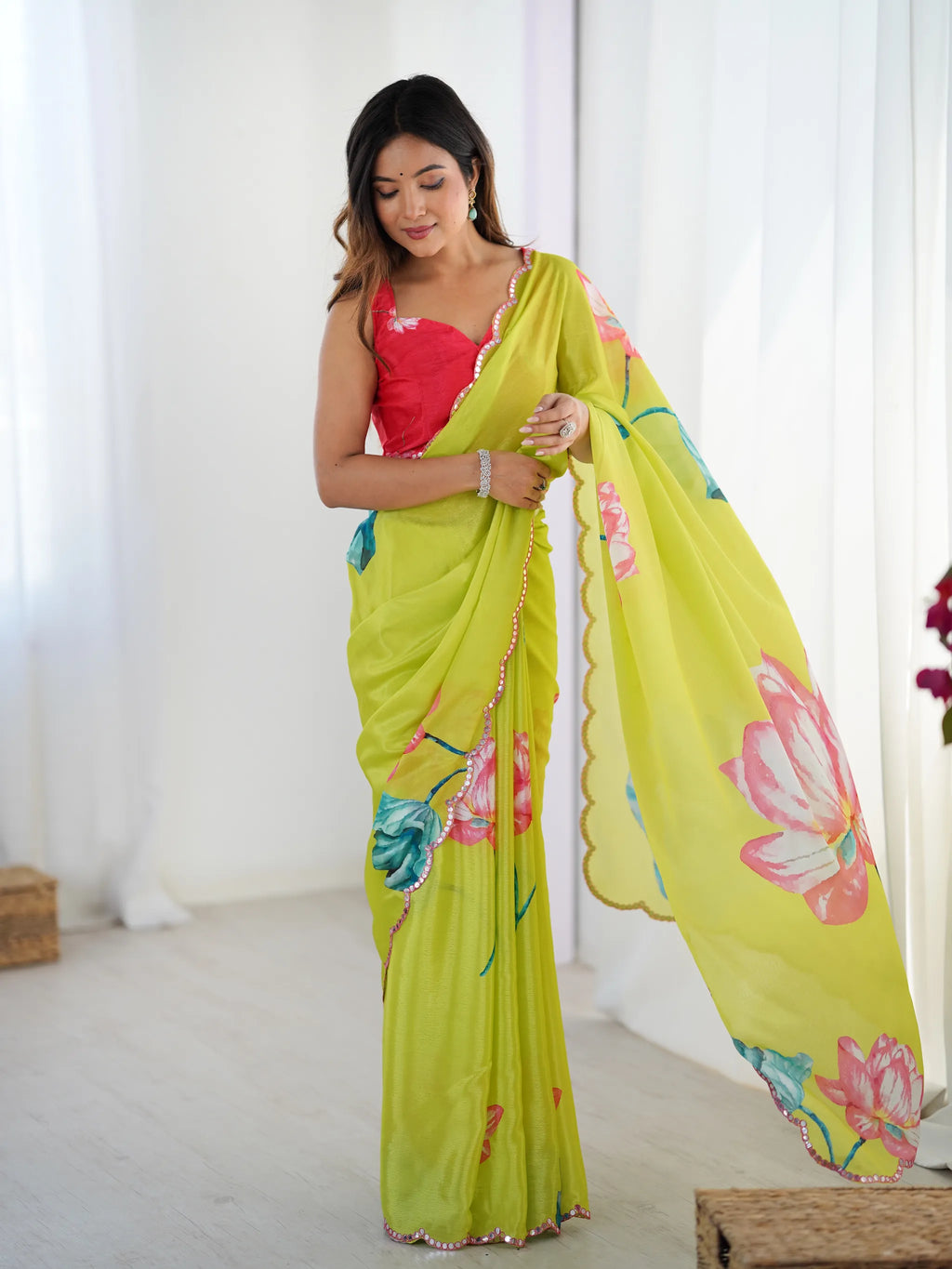 Model wearing lime green chinnon saree with floral print and pink blouse