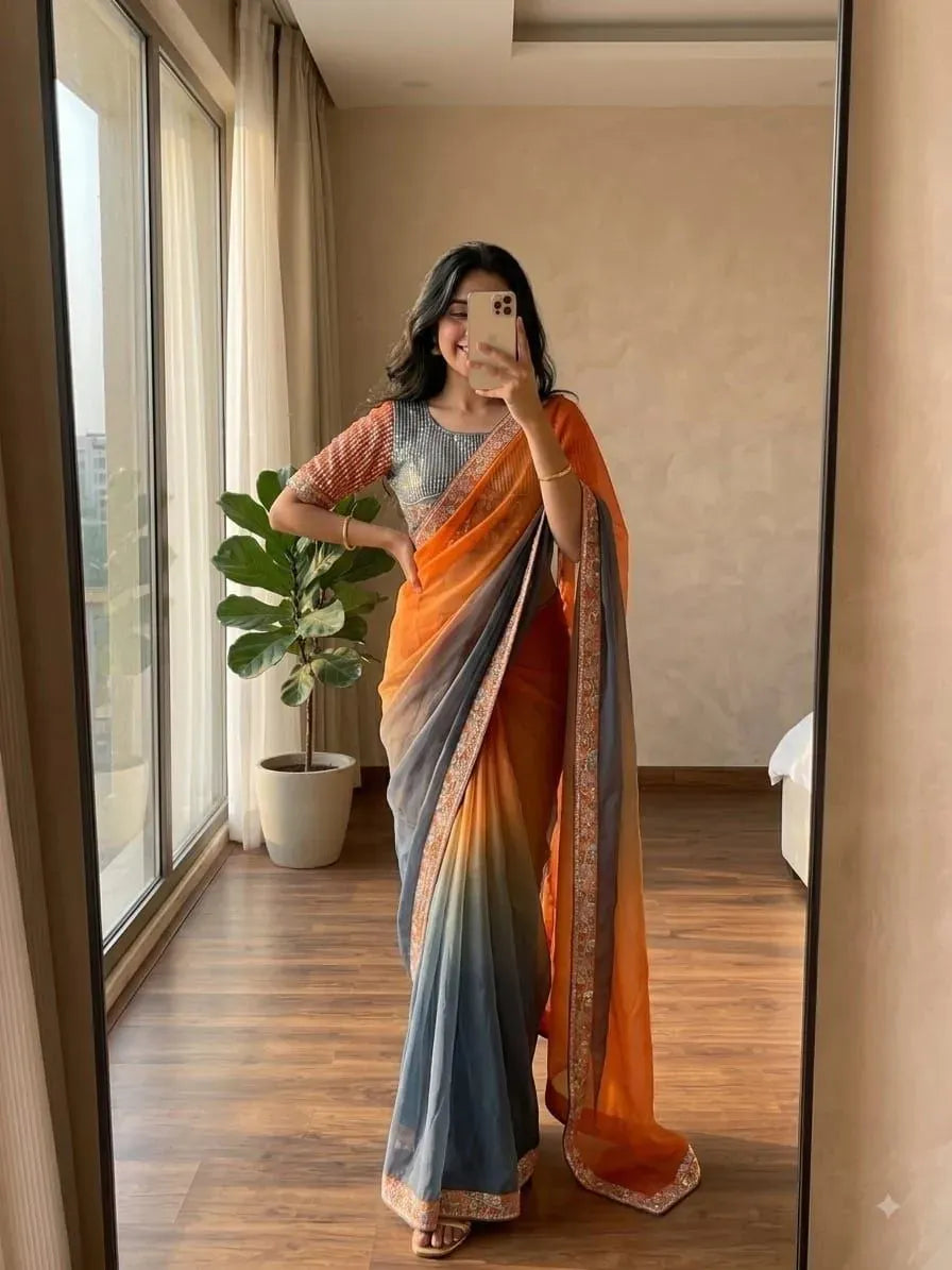 Model wearing gradient orange and grey satin saree with embroidered blouse