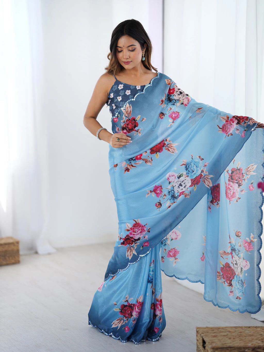 Model wearing blue floral printed heavy chinnon saree with mirror work border