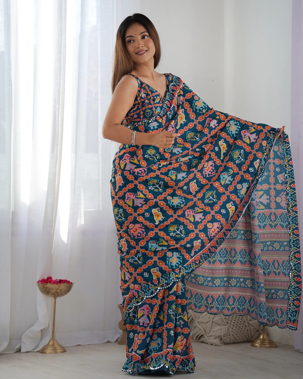 Full view of woman in blue patterned chinnon saree