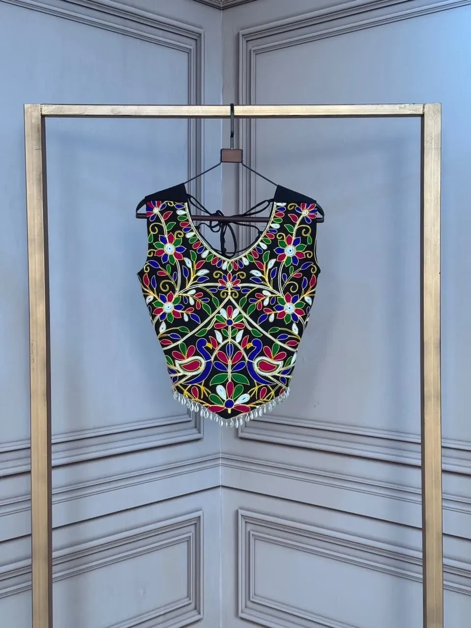 Black sleeveless rayon blouse with multi-color traditional Kutchi embroidery and hanging bead details