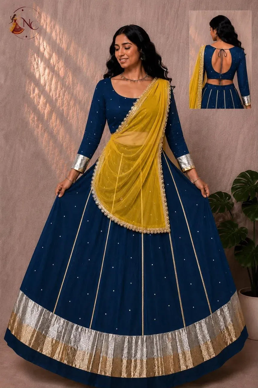 Model in navy blue lehenga with mustard yellow dupatta and silver border details