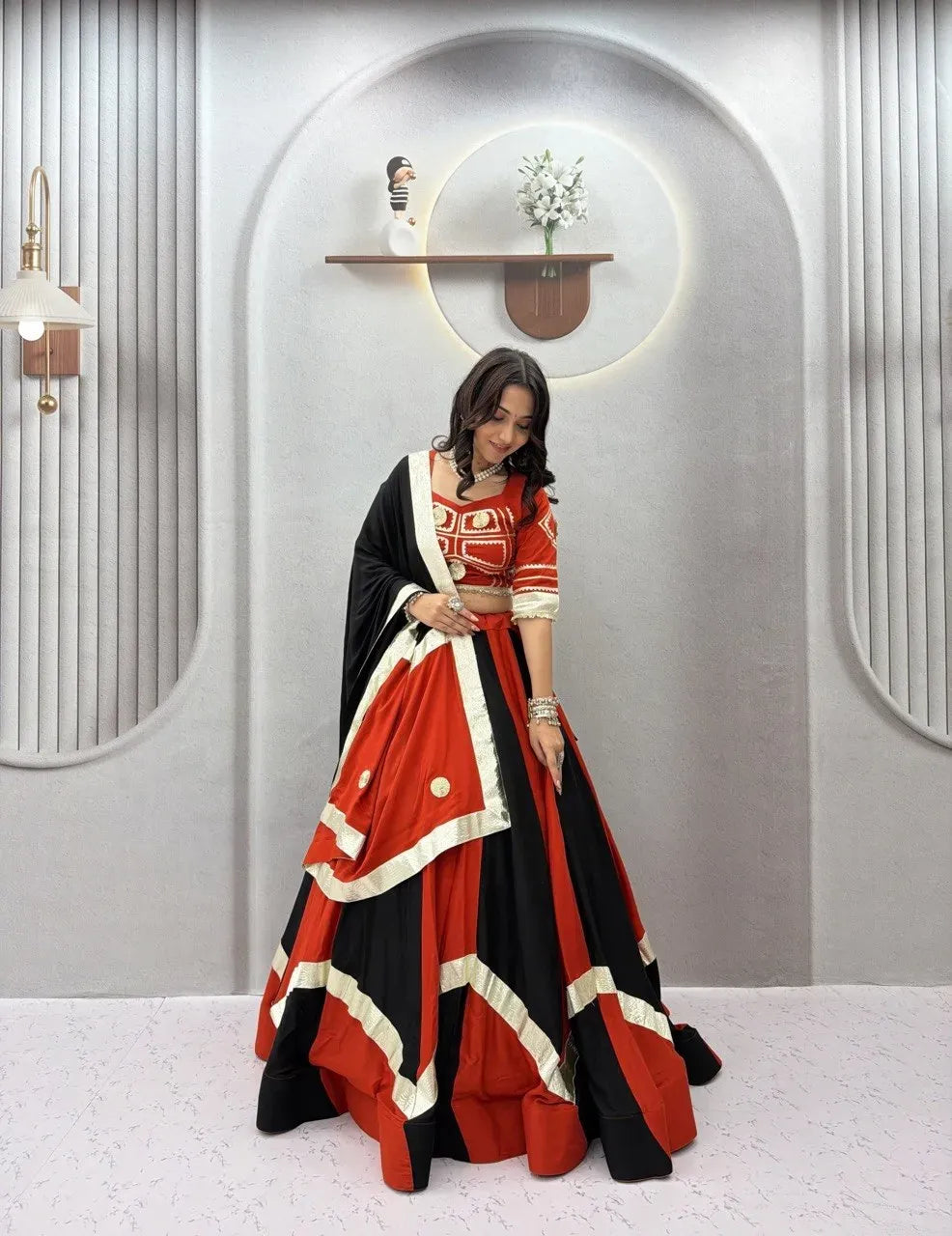 Model wearing red and black color blocked cotton lehenga with dupatta