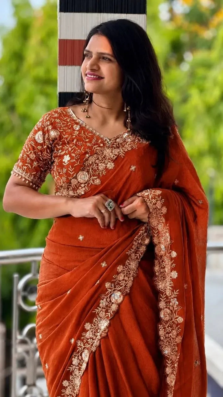 Model wearing rust orange rangoli crush sequence work saree