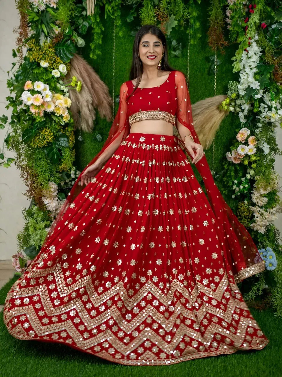 Full body view of woman in red traditional lehenga set