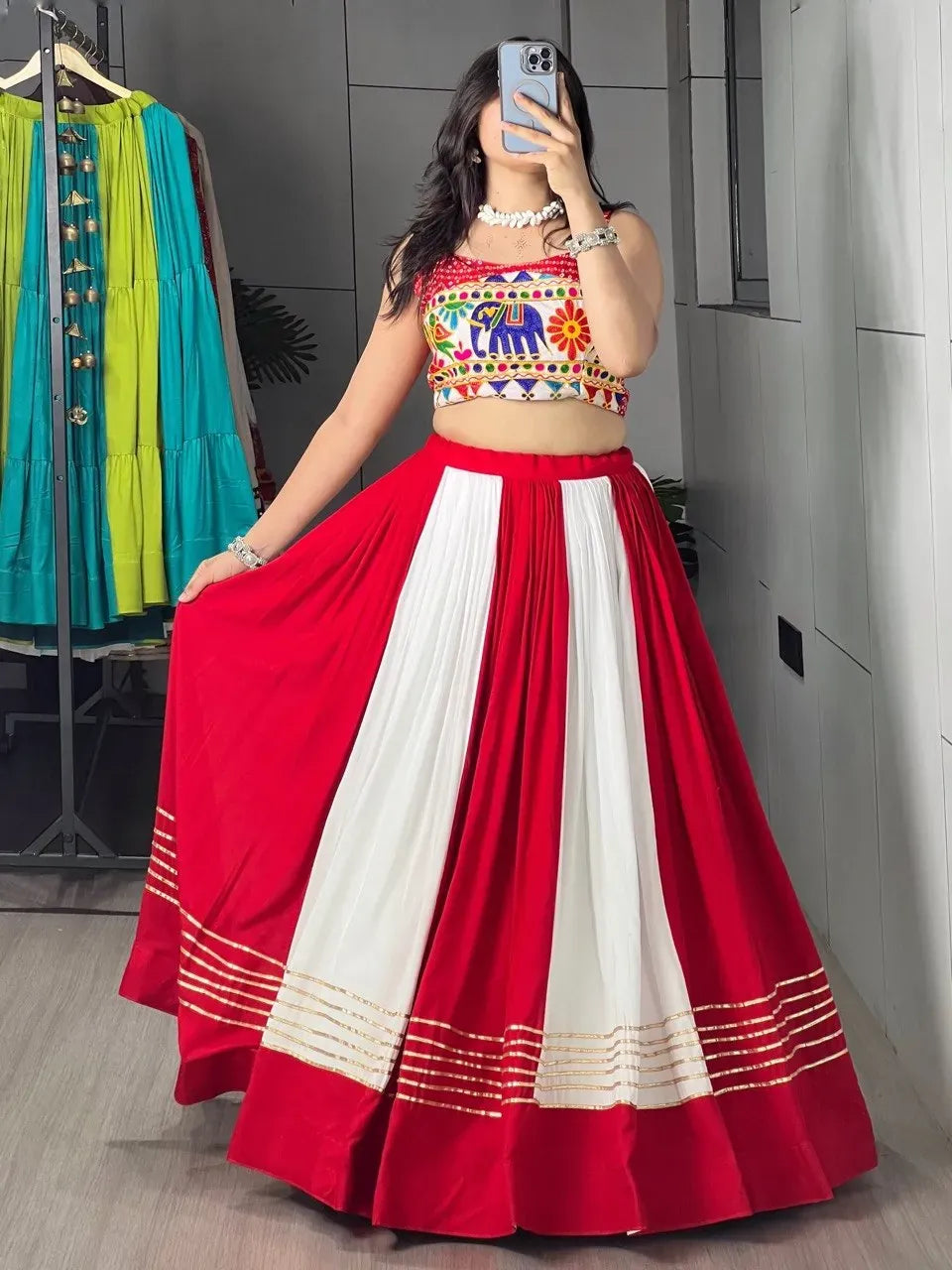 Woman wearing red and white chaniya choli set with Gota Patti work