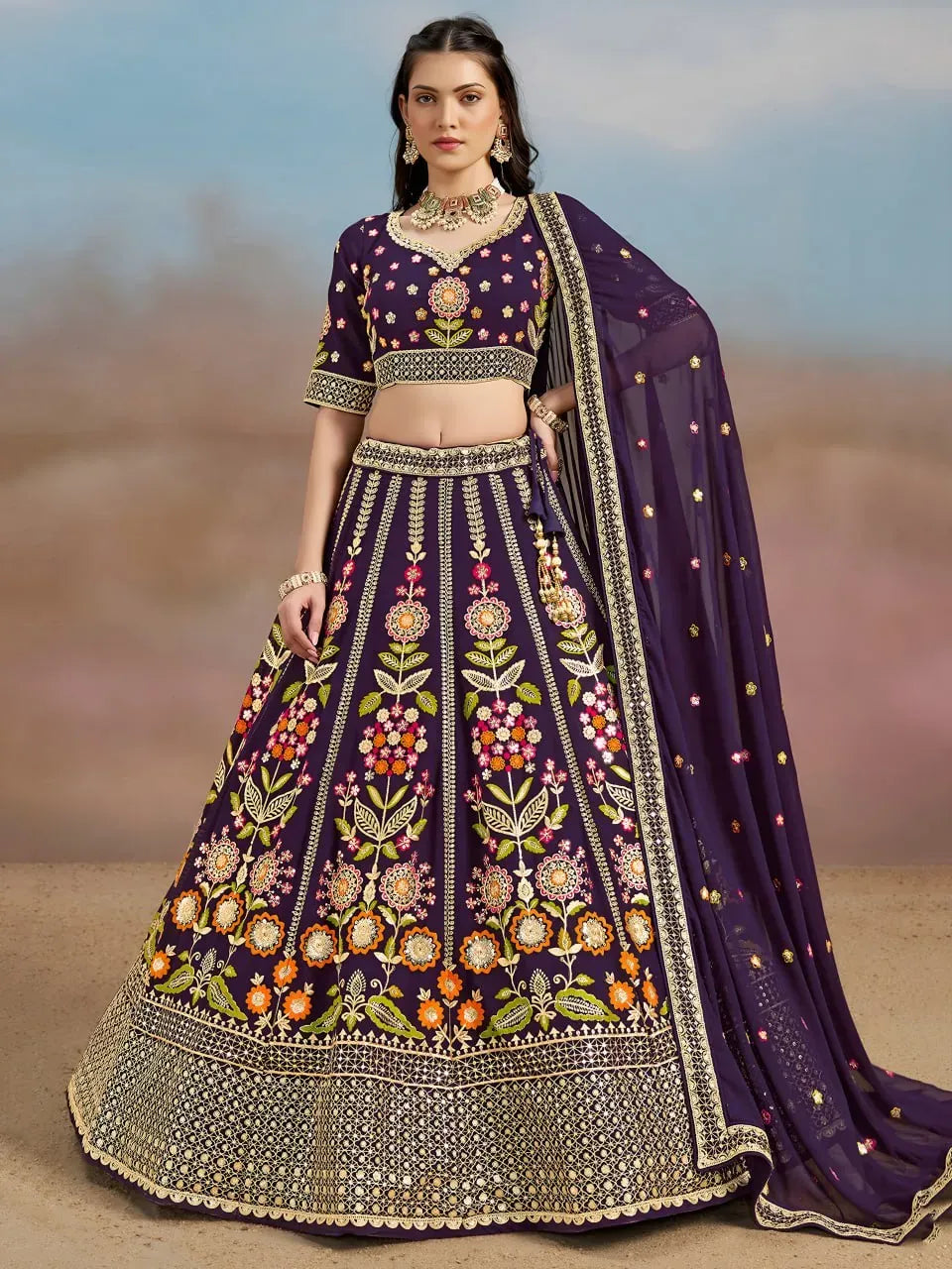 Model wearing royal purple georgette lehenga with multicolor floral embroidery and dupatta