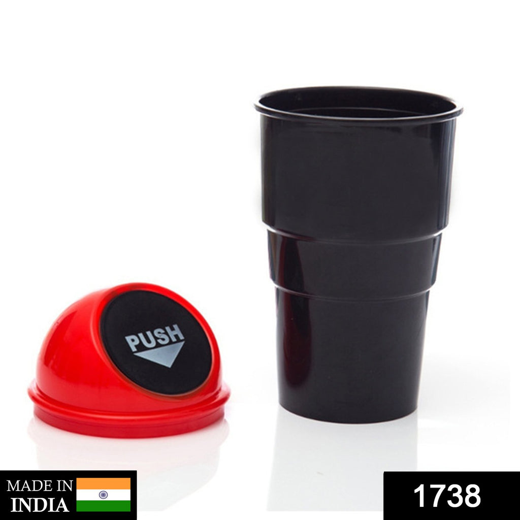 Hand holding 1738 mini car trash bin, cup holder dustbin with flip lid.