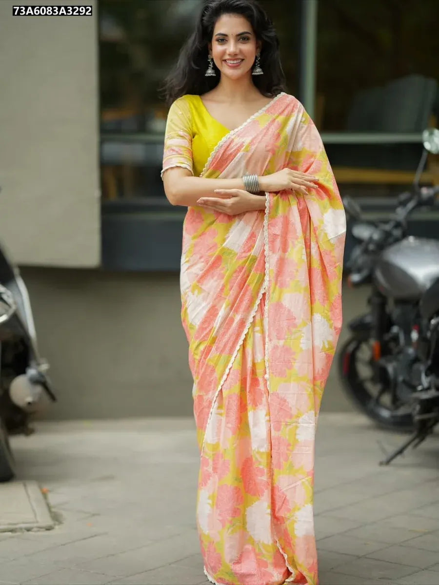 Full shot of a smiling model posing outdoors, wearing the TRENDBUY Tebby Silk Digital Print Saree with a yellow blouse and traditional earrings.