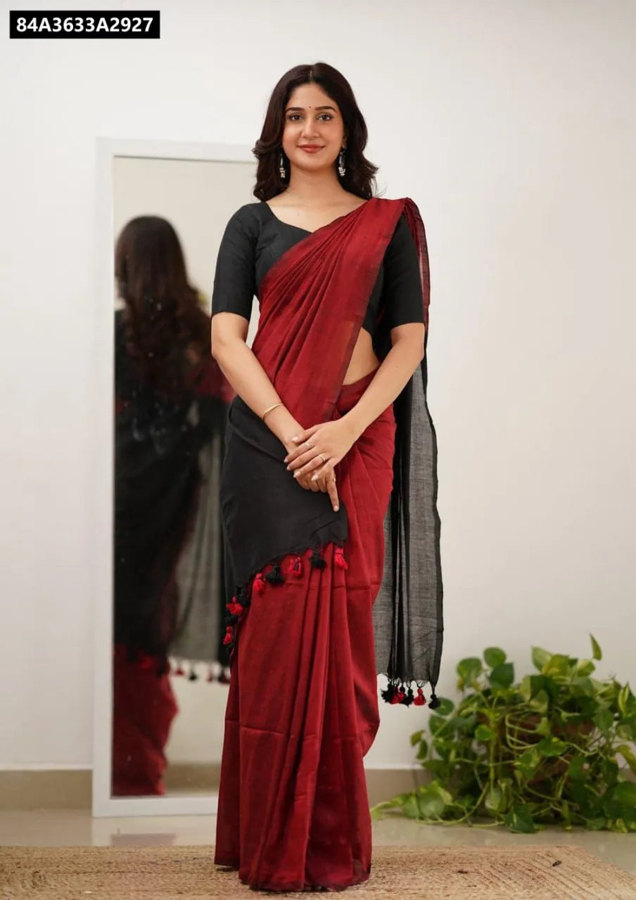 Model wearing a Scarlet Red Lilan Slab Saree with black blouse and pallu, featuring tassels.