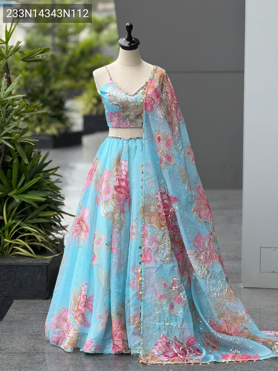 Full view of a TRENDBUY Aqua Blue Organza Lehenga Choli Set on a mannequin, showcasing vibrant digital floral prints, intricate embroidery, and real mirror work.