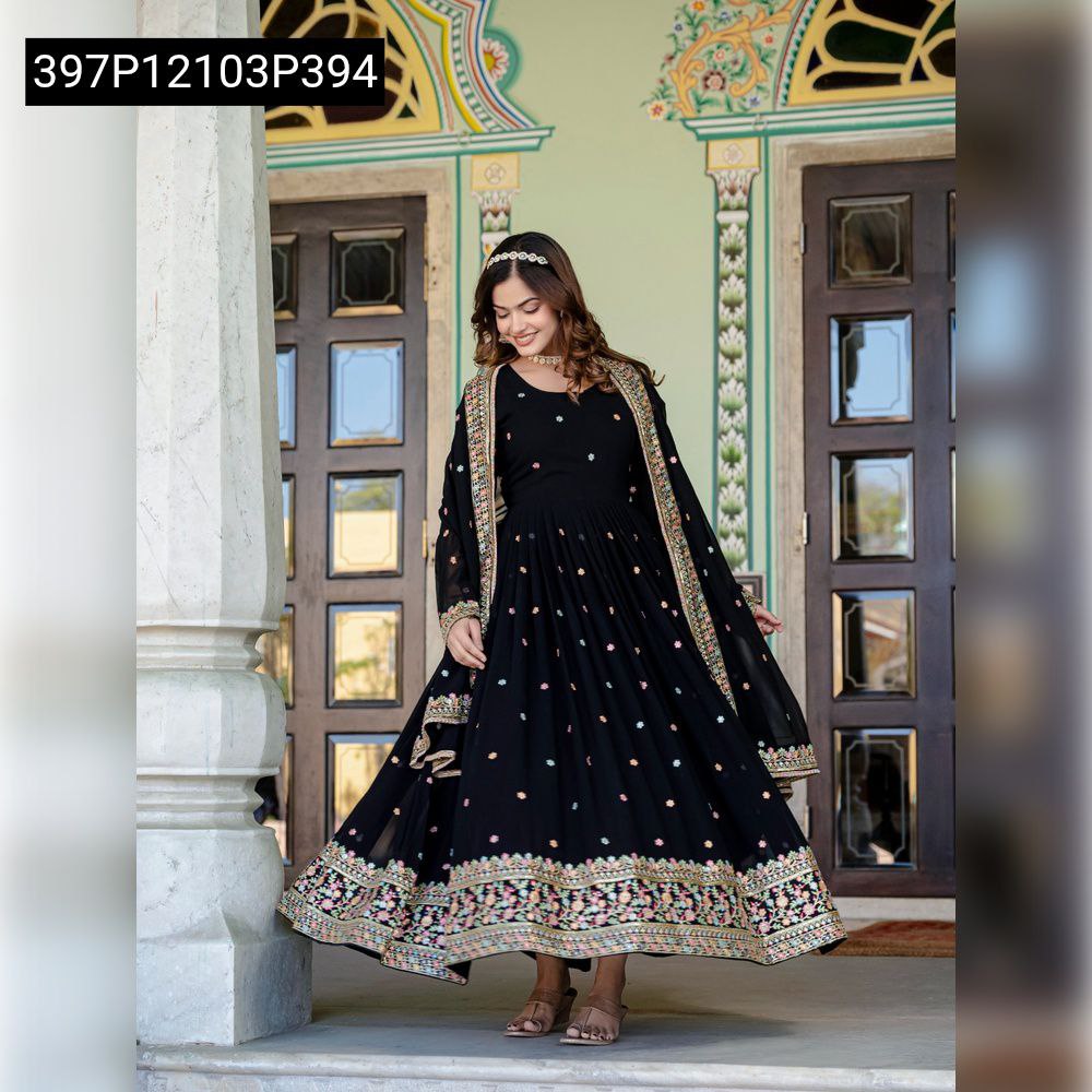 Full body shot of model gracefully twirling in a black anarkali gown, showcasing its generous 3.5-meter flair and intricate sequin & zari embroidered hem.