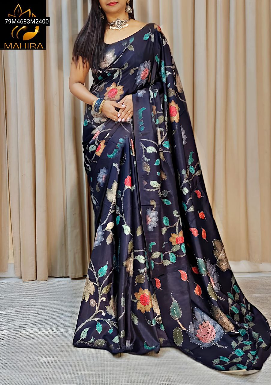 Full model shot of the TRENDBUY black georgette saree, illustrating its elegant flow and exquisite multicolor floral digital print with thread accents, against a curtained backdrop.