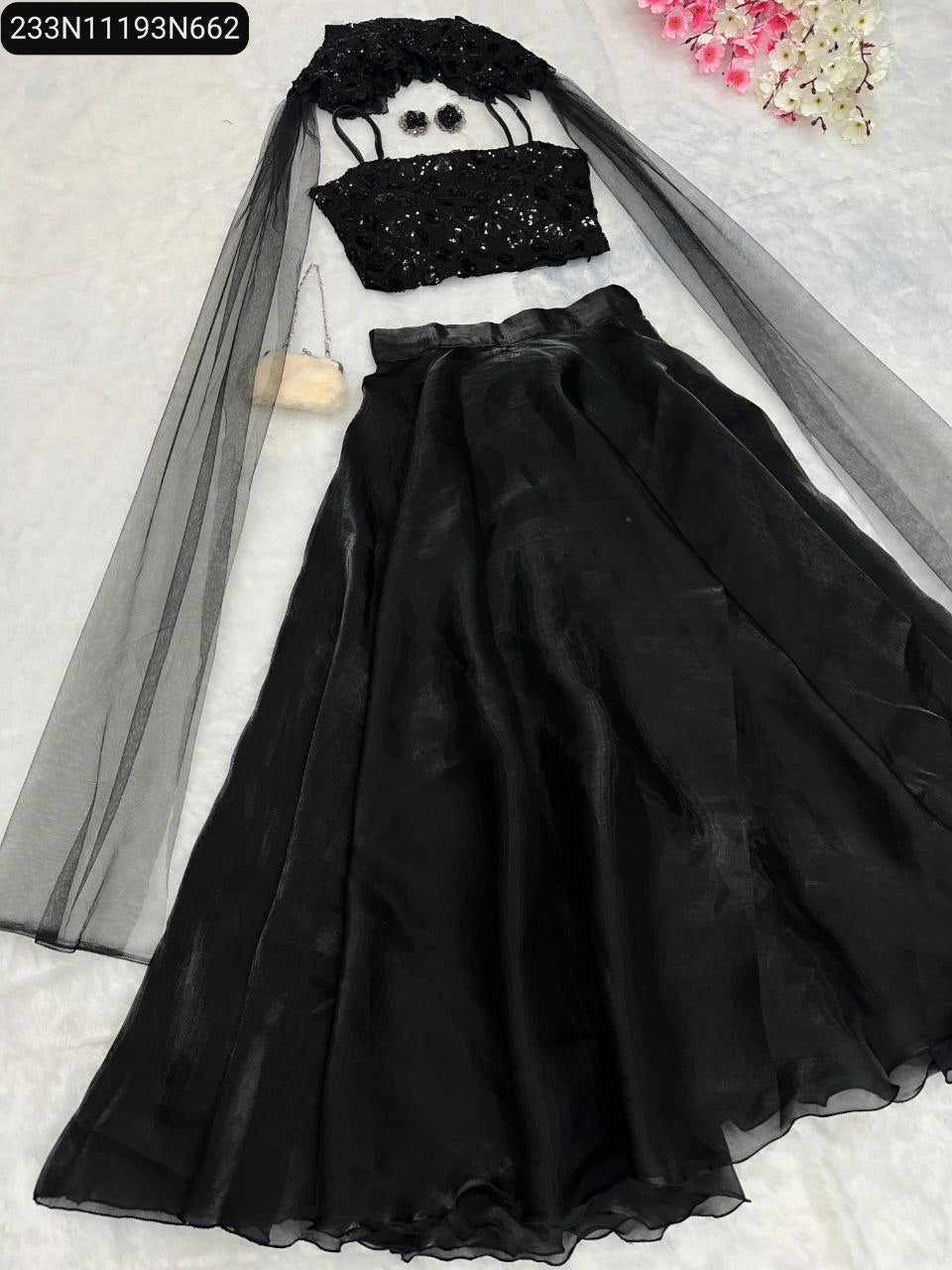Overhead view of the TRENDBUY black sequin embroidered lehenga set, showcasing the blouse, flowing lehenga, and the stylish net fabric tale georgette cape.