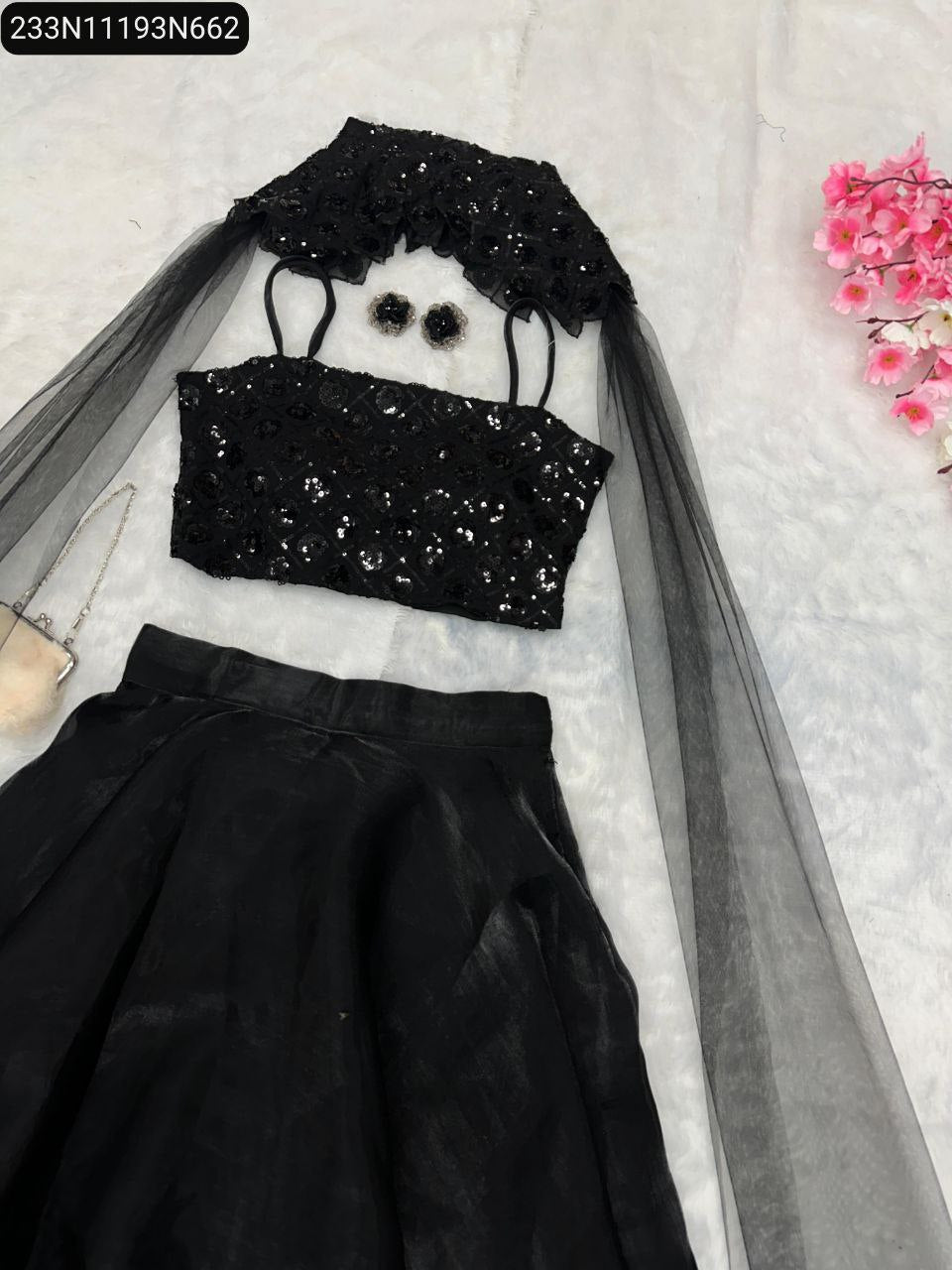 Close-up of the intricate sequin embroidery on the black georgette blouse