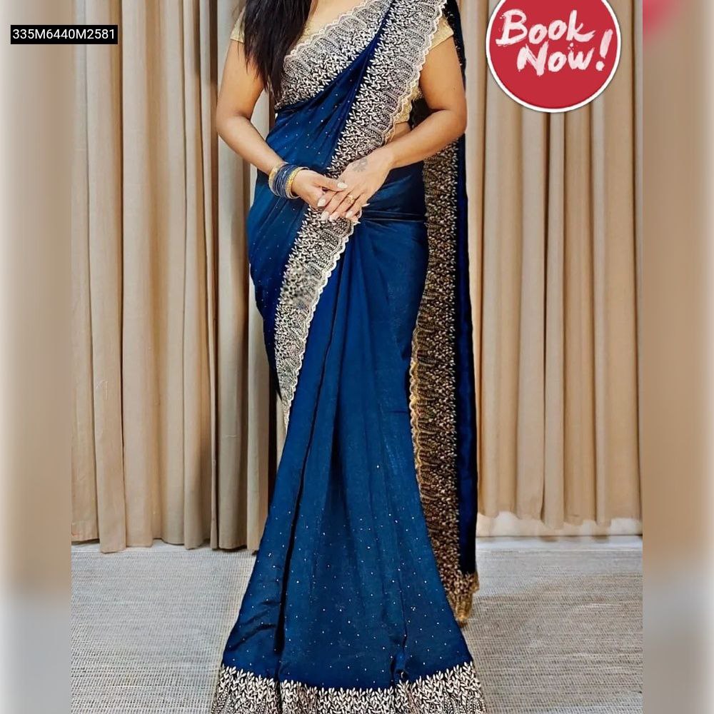 Full-length model shot showcasing a woman elegantly draped in a royal blue TRENDBUY Blooming Vichitra saree with a rich gold embroidered and cut-work border.